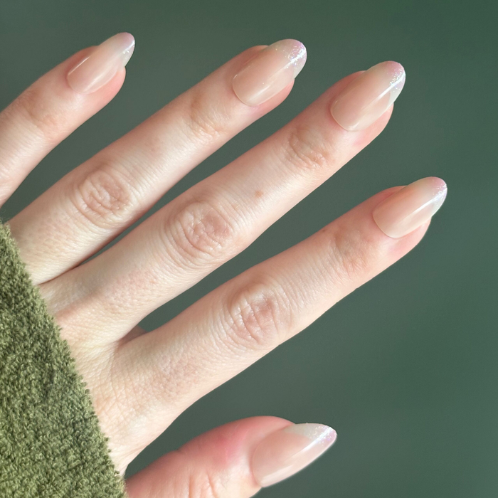 Party Glitter French - Press On | Medium | Oval neutral manicure with subtle glitter french tips on medium oval false nails