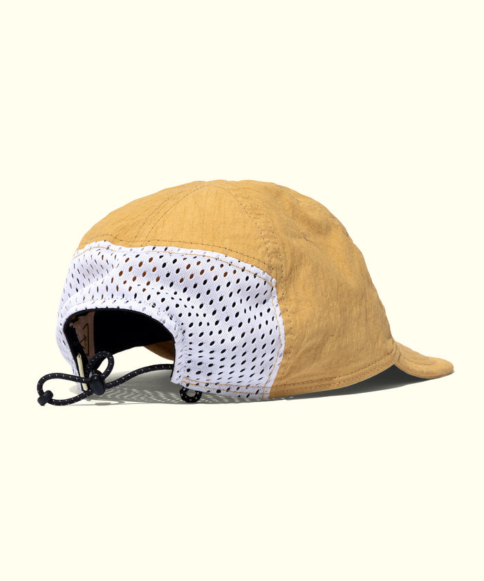 Yellow cap with white mesh back on a white background