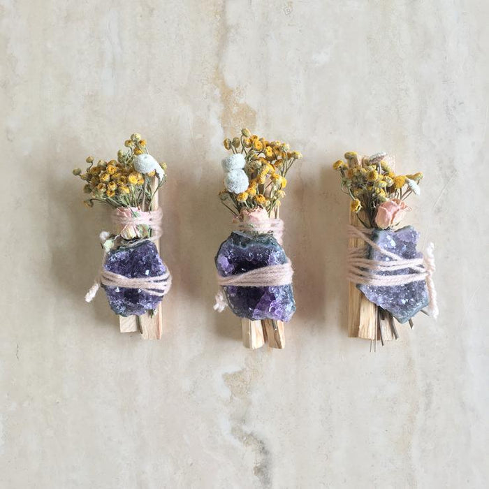 Palo santo bundle set with dried flowers and purple amethyst stones, three pieces.