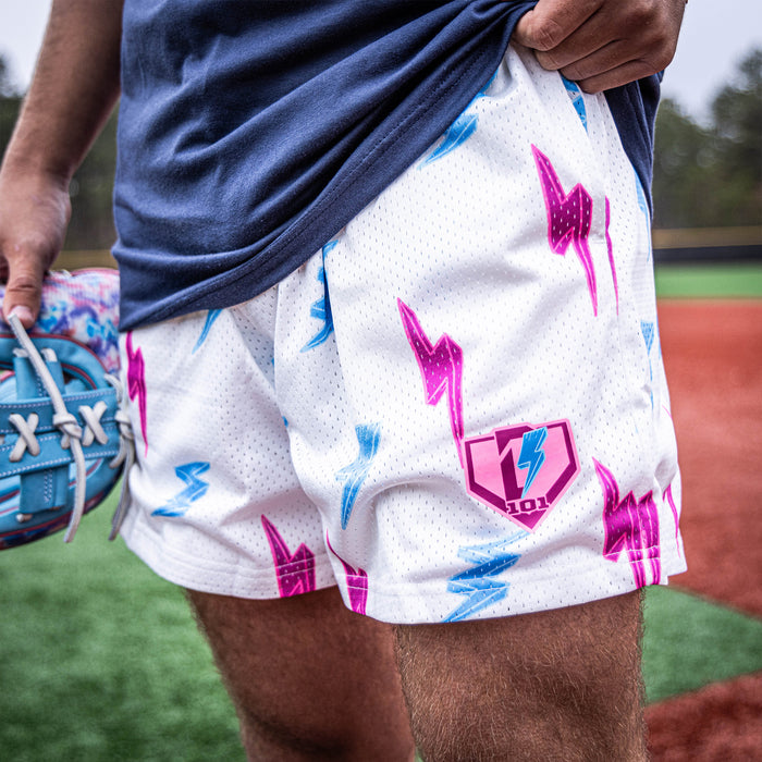 Youth model wearing white Rain Delay Lightning Bolt youth shorts
