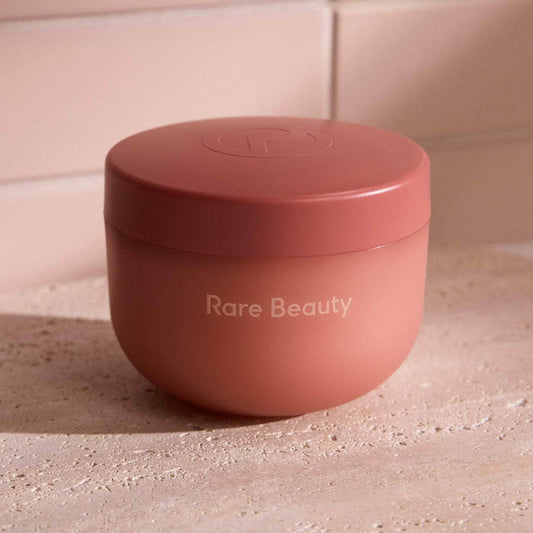 Rare Beauty Find Comfort Bouncy Body Cream with hyaluronic acid, shown in a sleek jar with a smooth, creamy texture.