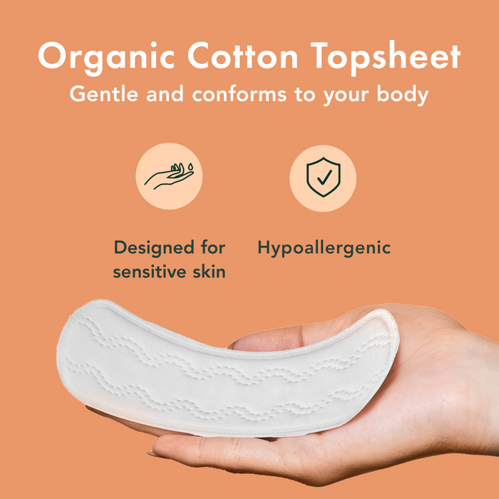 Organic cotton topsheet held in a hand with features highlighted on an orange background