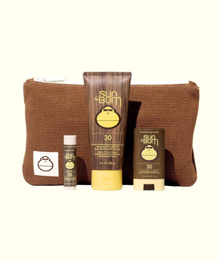Road Tripper travel kit with SPF 30 sunscreen, lip balm and face stick in brown corduroy bag by Sun Bum