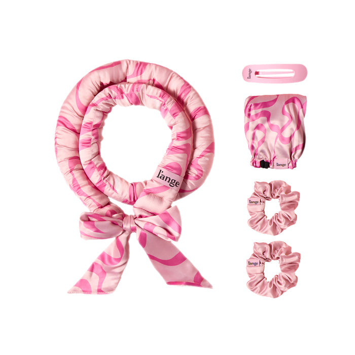 Satin Heatless Curls Set on a white background.  Set includes curling rod, an adjustable bonnet, two scrunchies, and a hair clip