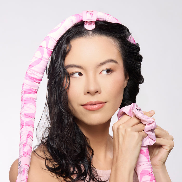 model using ans twisting hair on Satin Heatless Curls Set on  satin curling rod