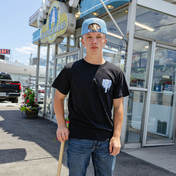 Adult model wearing graphic tee with "Scoop SZN" design