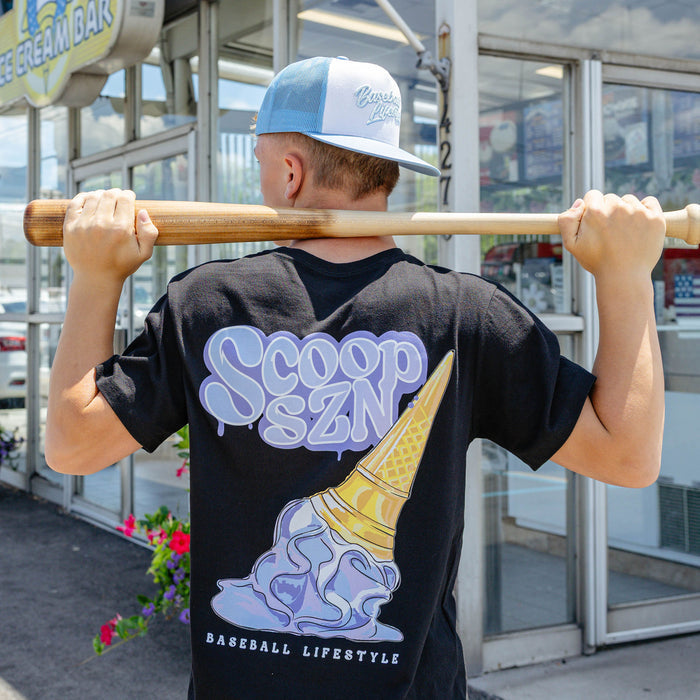 Adult model wearing graphic tee with "Scoop SZN" design