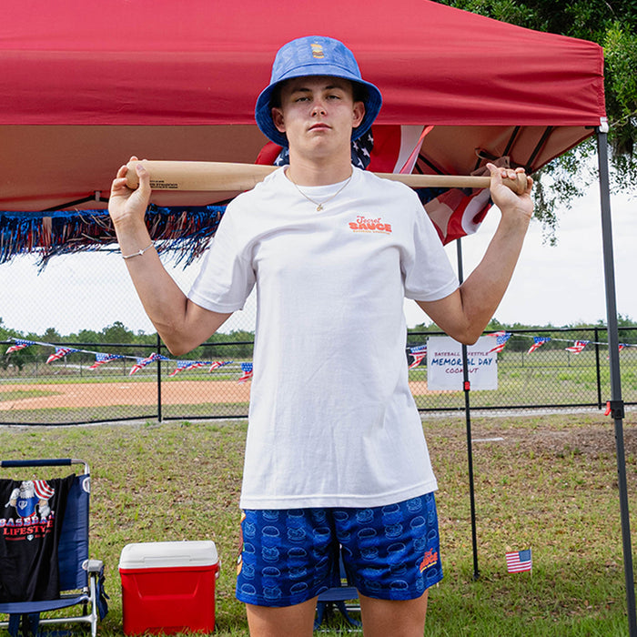 Person holding a baseball bat under a red tent wearing a white t-shirt with 'Secret Sauce' text