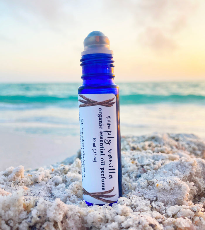Organic vanilla perfume oil roll-on made with vanilla absolute in a blue glass bottle – natural long-lasting vanilla scent.