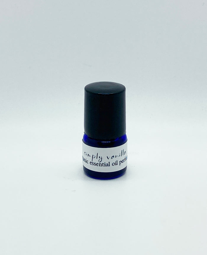 1ml Simply Vanilla essential oil perfume roll-on in a blue glass bottle with black cap, labeled organic vanilla perfume, shown against a white background.
