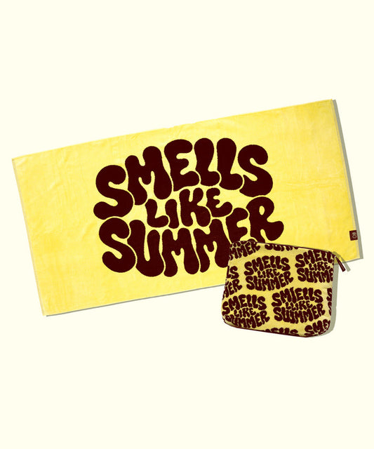 Yellow towel with 'Smells Like Summer' text and matching pouch on a white background