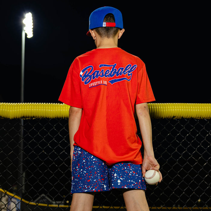 Youth model wearing red, white & blue Splatter USA youth shorts