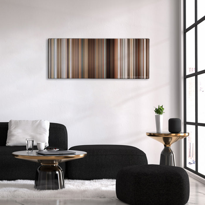 Stranger Than Fiction color palette canvas above a black sofa with a gold-topped table