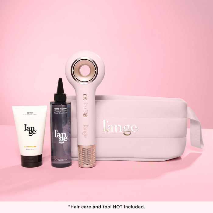 L’ange essential bag with hair dryer and two hair care products on the side. Text reads "hair care and tool NOT included"