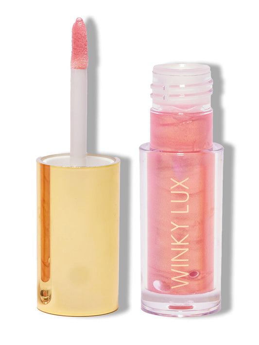Pink opal shimmer -- nourishing golden pink lip oil with cap off on white background