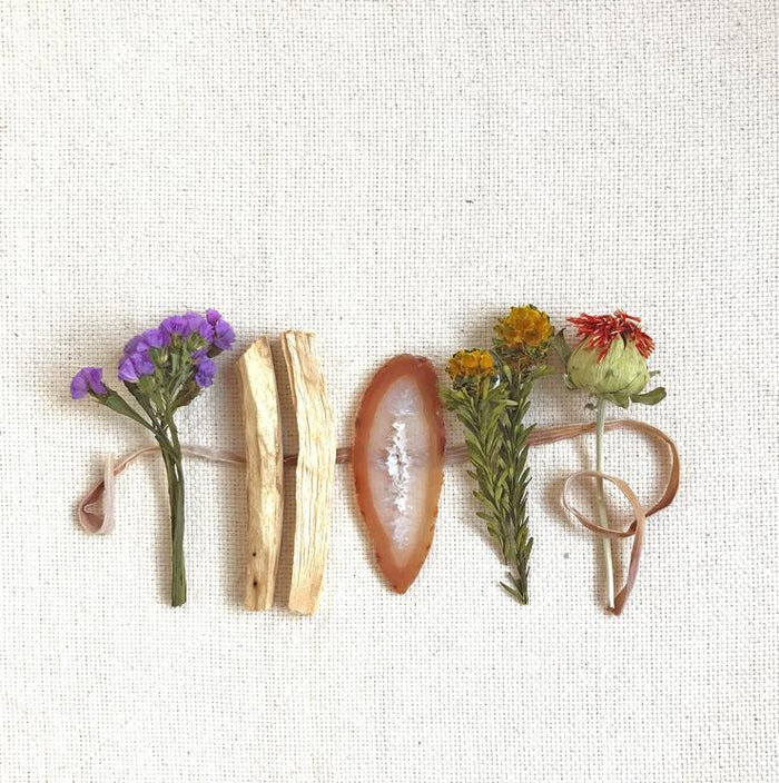 Wood Creek Palo Santo bundle set with dried flowers, light wood sticks, and an oval piece