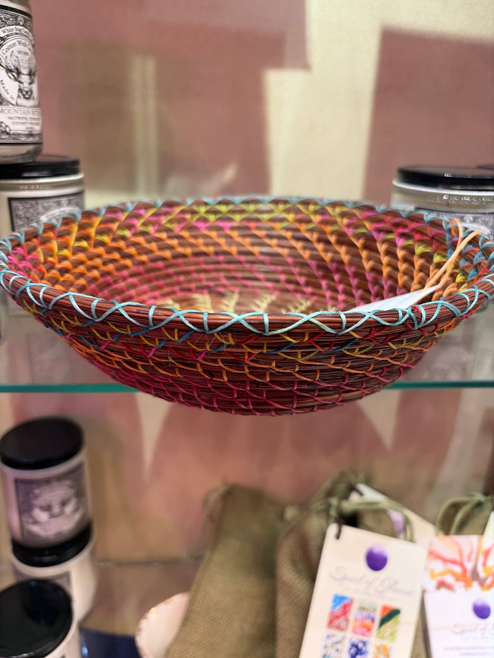 Three woven pine needle baskets by Whispers of Pine, showcasing intricate handwoven texture and natural earthy tones.